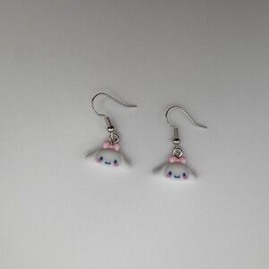 Cinnamoroll character design featuring white dog w/pink bow design